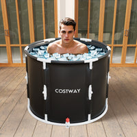Man using a Costway foldable 250L ice bath and cold plunge tub with ice on a wooden deck.